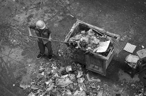 A small skip and van parked on a residential street in Honor Oak ready for collection